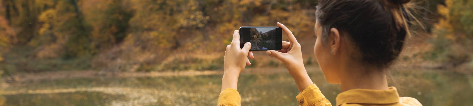 Girl Taking a Photo with a Mobile Phone in the Fall
