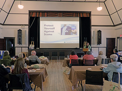 Large Presentation Screen in front of People sitting at tables