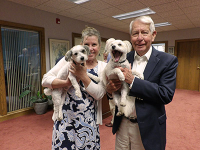 Deena and Rob Holding Dogs Zoom and Lilly