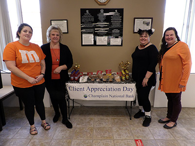 Jayne, Michelle, April, and Cheryl standing next to a food table