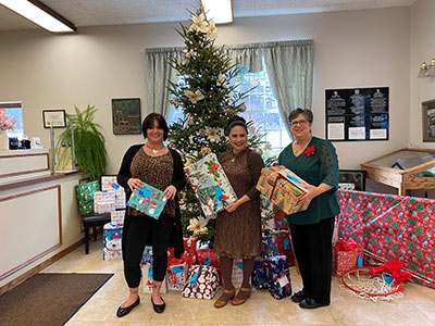 Three Women Holding Presents