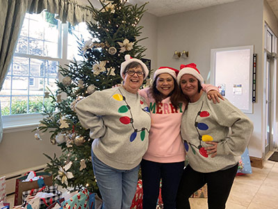 Group of People Wearing Christmas Sweaters