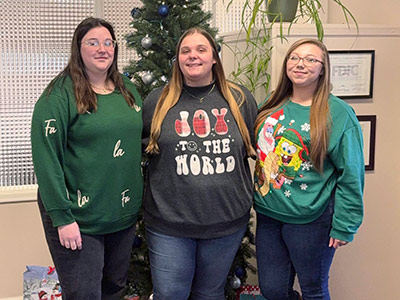 Group of People Wearing Christmas Sweaters