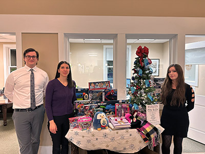 Three People Next to Table of Toys